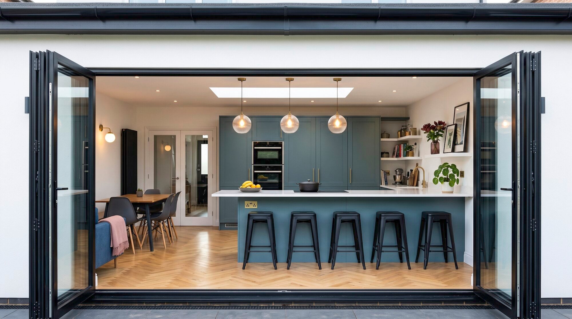 Shaker kitchen in an extension with bifold doors