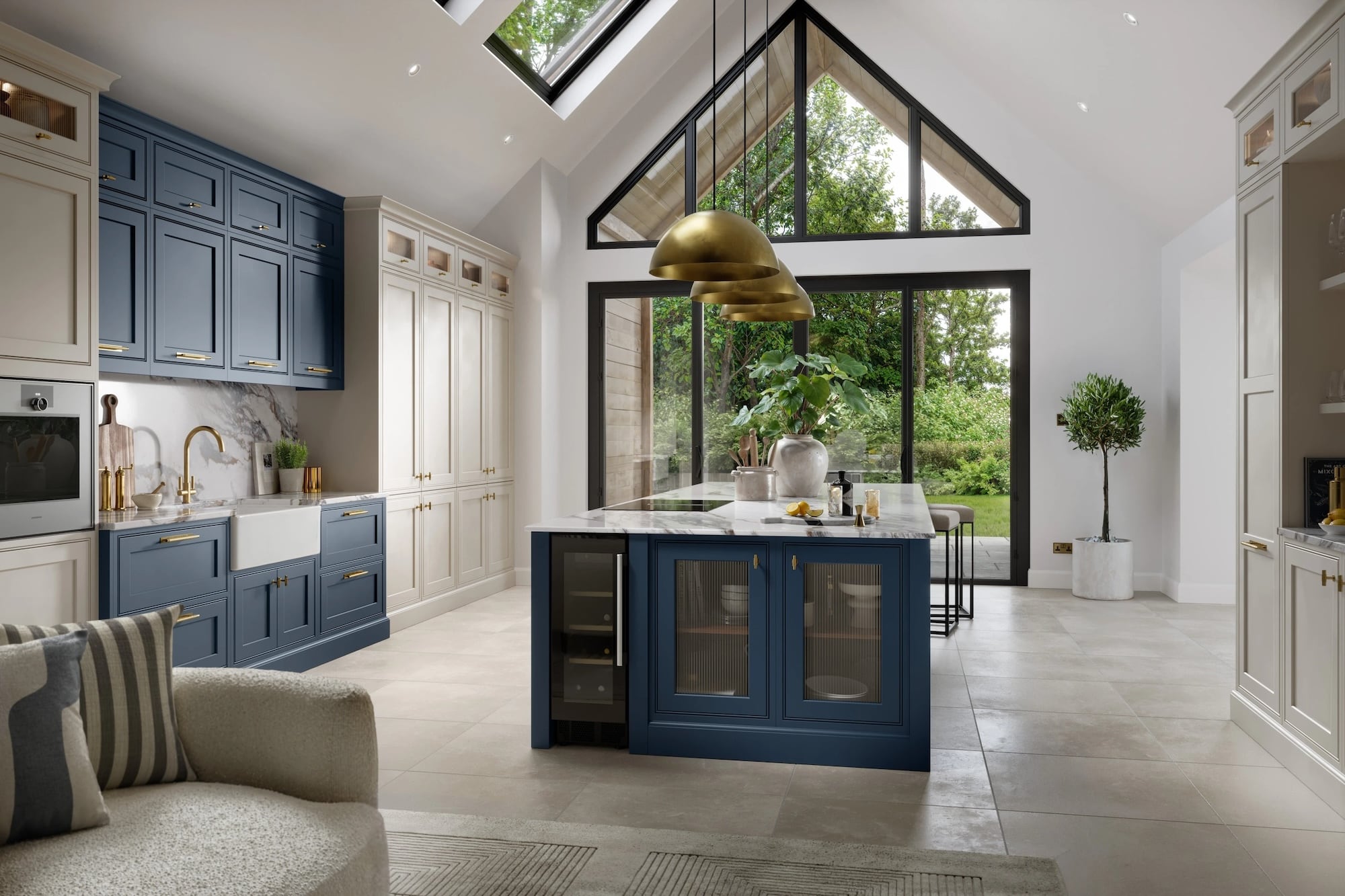 Bespoke kitchen in Witney with blue cabinets, white countertops, and large windows.